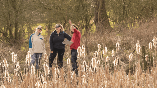 Visitors completing a grass survey with a ranger at Hardwick, Chesterfield.